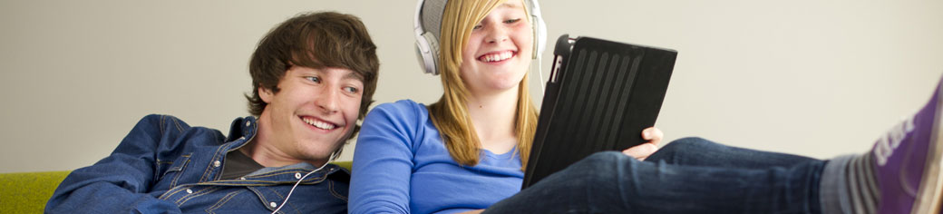 Man Women Laptop relaxing on Sofa - UTStarcom